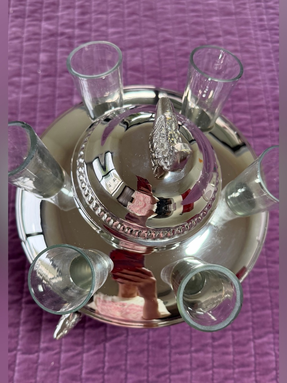 Silver-colored caviar bowl with vodka glasses - an elegant table centerpiece.